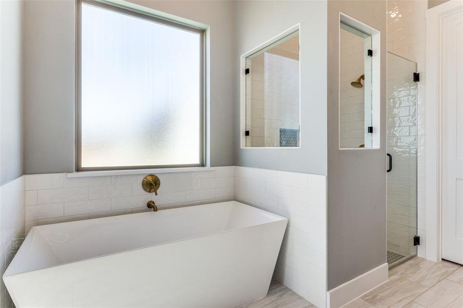 Bathroom with a freestanding bath and a stall shower Bathroom with a freestanding bath and a stall shower