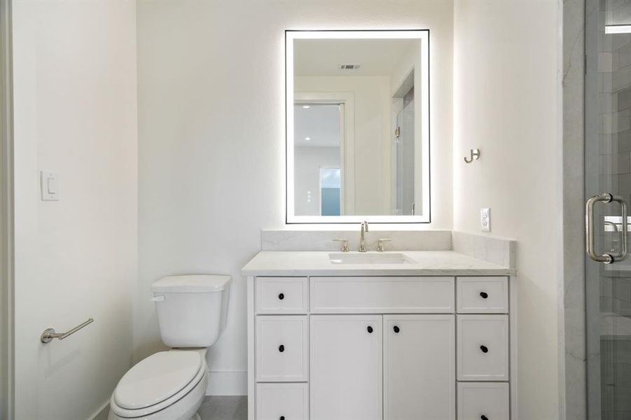 Full bath with vanity and a stall shower Full bath with vanity and a stall shower