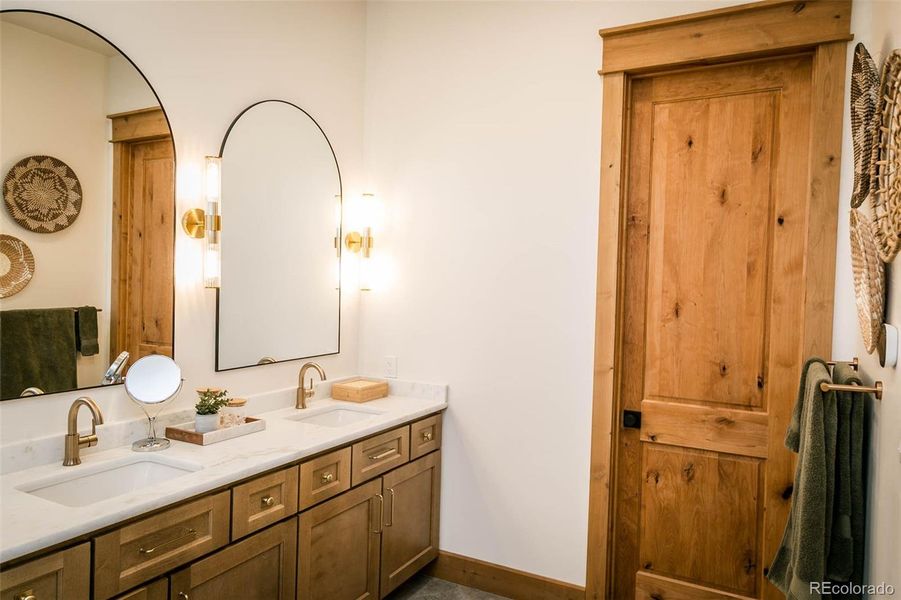 Primary bathroom; 5 piece bath with Iceberg leathered granite, 2 sinks and a private water closet.