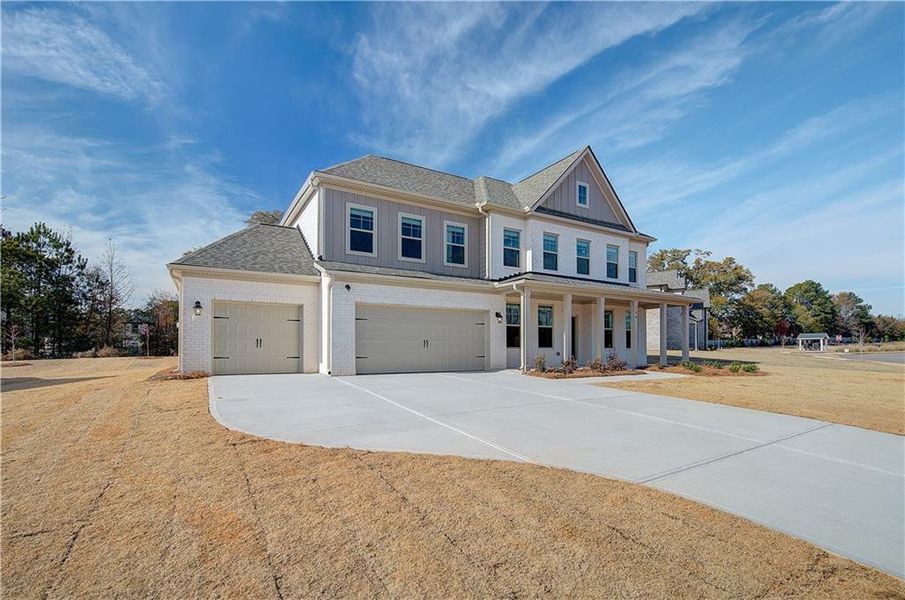 Front exterior of a new home in Cambria at Traditions, Hampton, GA, highlighting curb appeal (Image 21).