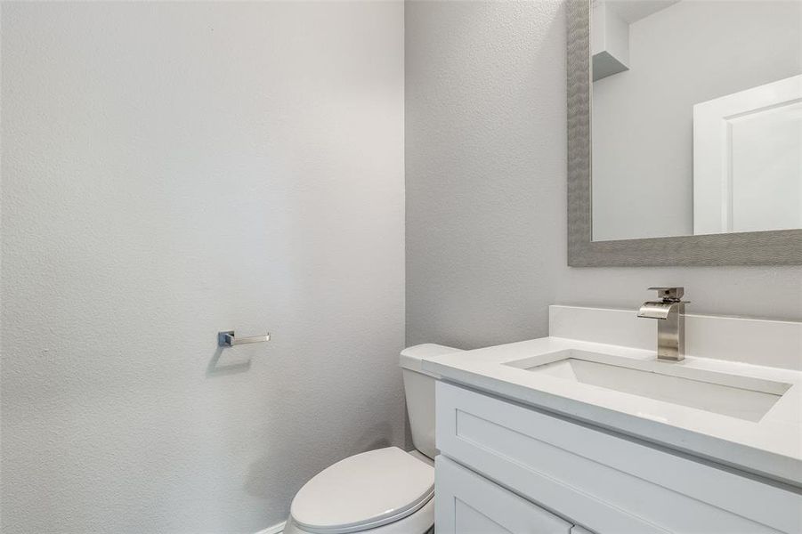 Bathroom featuring vanity and toilet