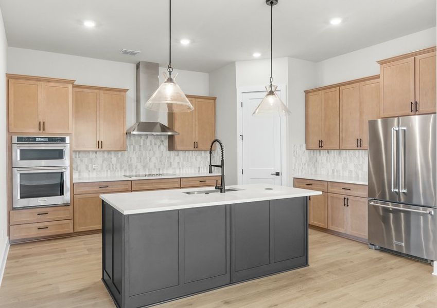 The kitchen has beautiful designer wood cabinetry.