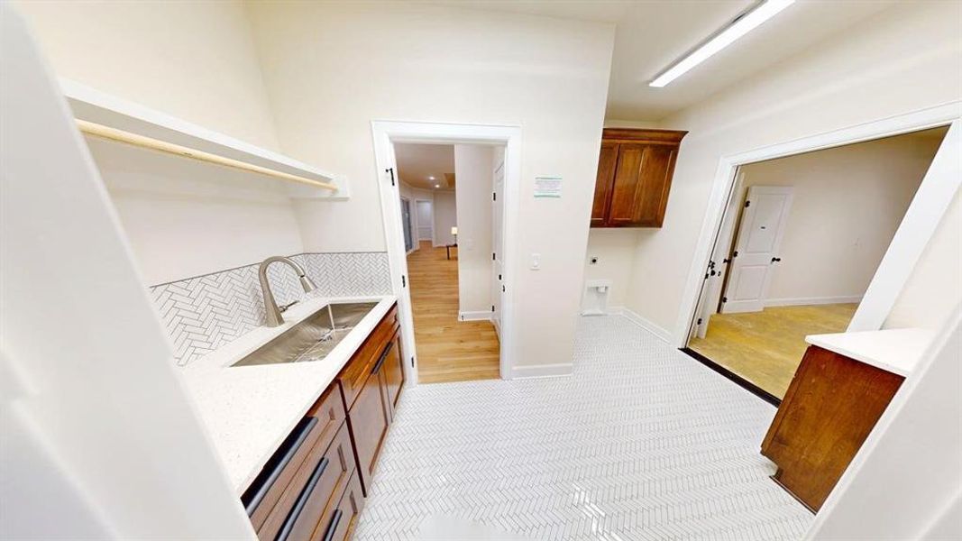 Bar area with a sink and light colored carpet