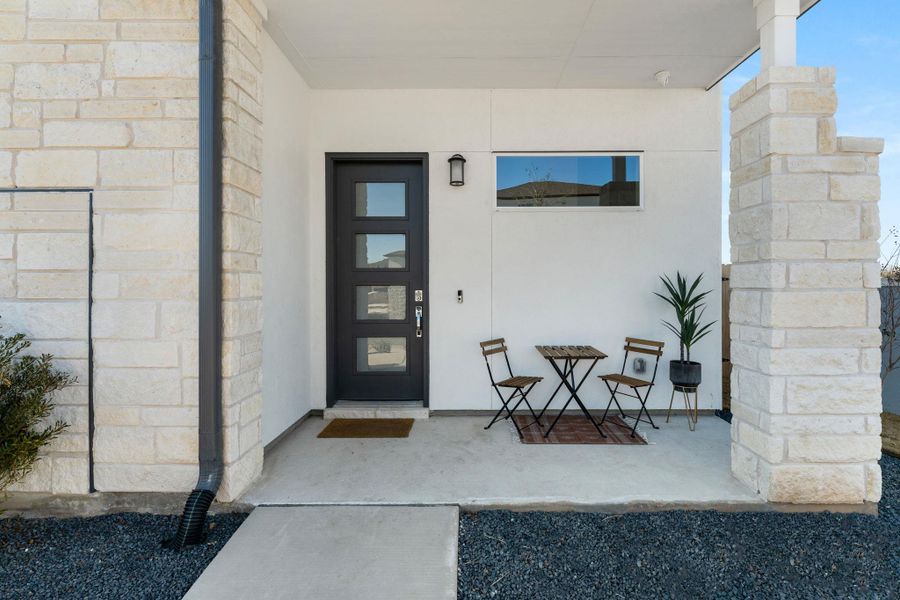 View of exterior entry featuring stucco siding and stone siding View of exterior entry featuring stucco siding and stone siding