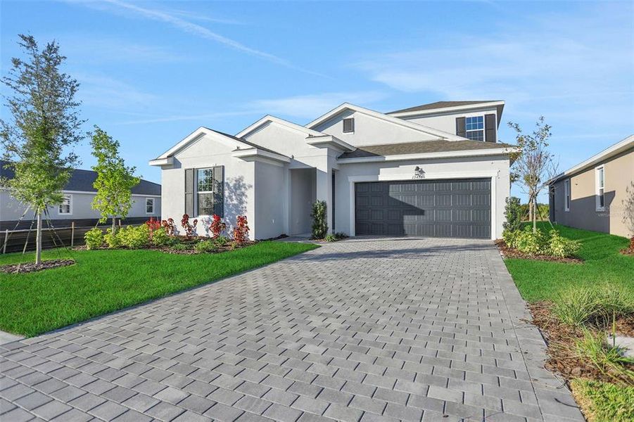 Front exterior of a new home in Turnleaf, Punta Gorda, FL, highlighting curb appeal (Image 24).
