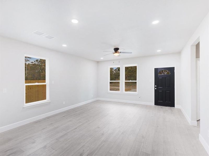 Empty room with recessed lighting, light wood-style flooring, and a ceiling fan