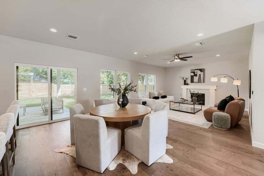 An inviting open-concept living space features hardwood flooring and abundant natural light. An inviting open-concept living space features hardwood flooring and abundant natural light.