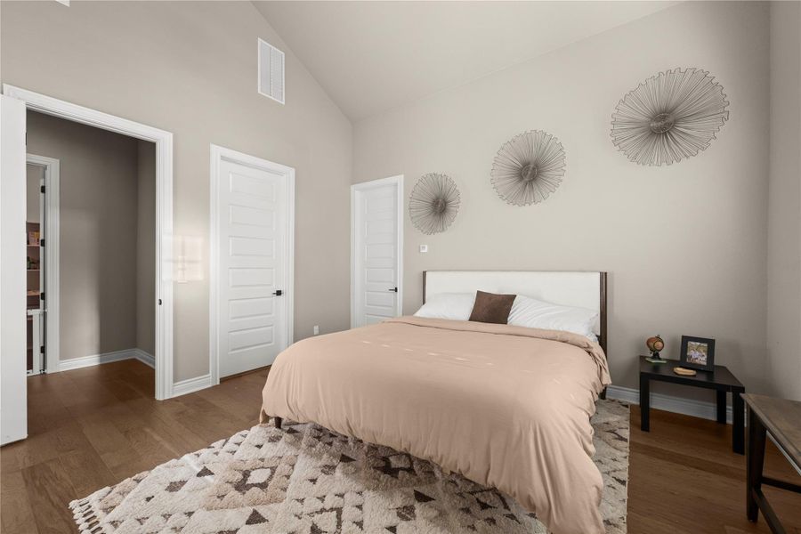 Hardwood flooring extends throughout this naturally illuminated bedroom with high vaulted ceilings. Hardwood flooring extends throughout this naturally illuminated bedroom with high vaulted ceilings.
