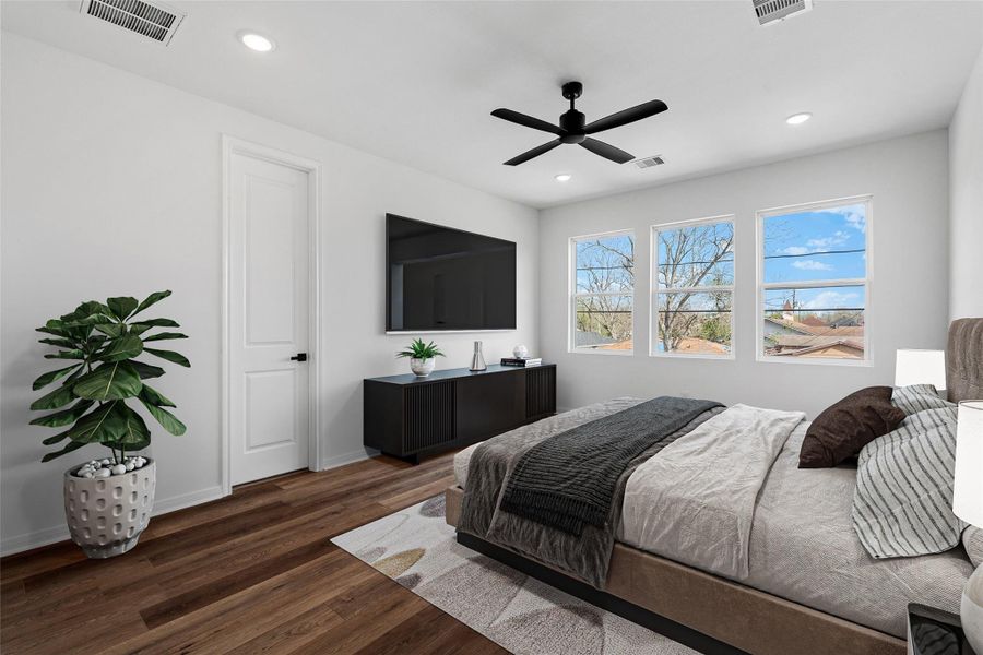 Virtually staged primary suite highlighting a king-size bed, nightstands, and cozy seating area to show the room’s full potential.