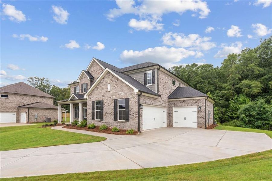 Front exterior of a new home in Windsong Estates, McDonough, GA, highlighting curb appeal (Image 2). Front exterior of a new home in Windsong Estates, McDonough, GA, highlighting curb appeal (Image 2).