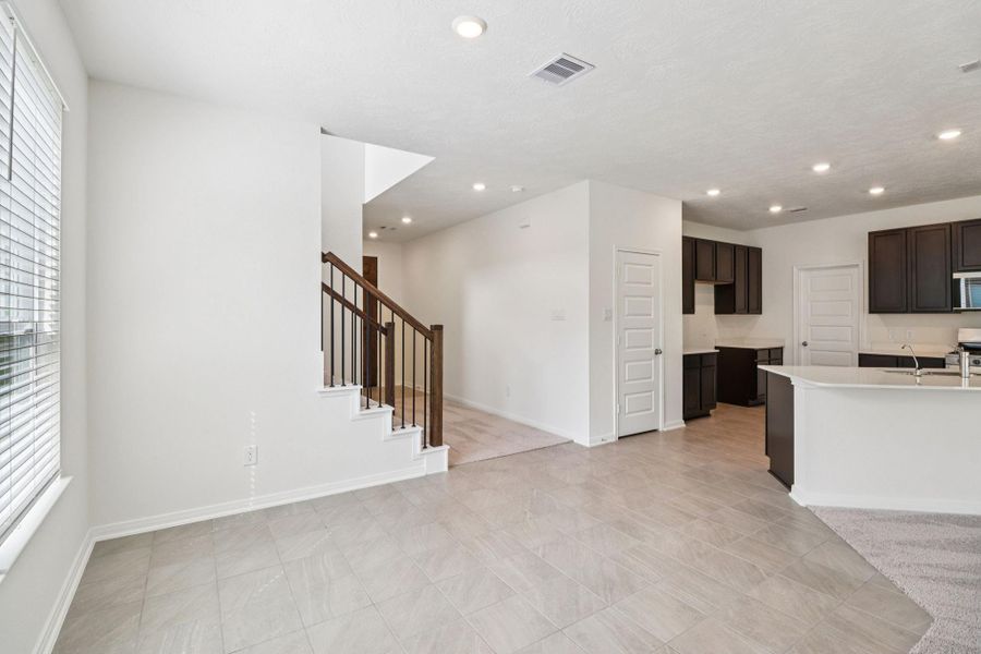 Start your day off right with a cup of coffee sitting with your family in the lovely dining area! Featuring large windows with privacy blinds, custom paint, tile flooring and recessed lighting.