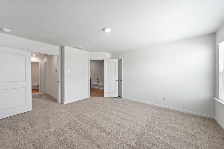 Bedroom with light colored carpet