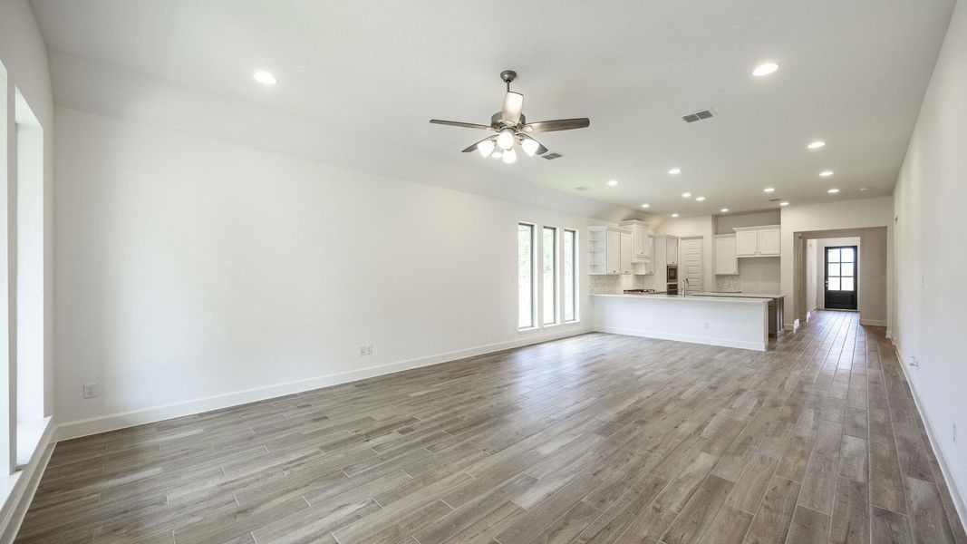 Unfurnished living room featuring recessed lighting, ceiling fan, healthy amount of natural light, and light wood-style flooring Unfurnished living room featuring recessed lighting, ceiling fan, healthy amount of natural light, and light wood-style flooring
