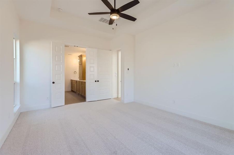 Unfurnished room with ceiling fan and light carpet