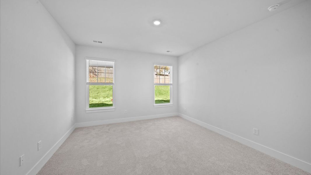 Eye-catching details and elegant finishes in the vibrant primary suite of this select home