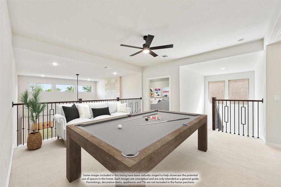 Open upstairs game room with pool table, seating area, ceiling fan, and iron stair railing on carpet flooring