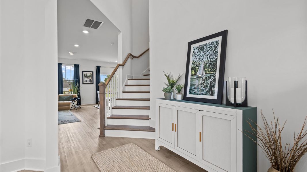 Elegant foyer with tasteful decor and thoughtful trim detail creates a memorable first impression
