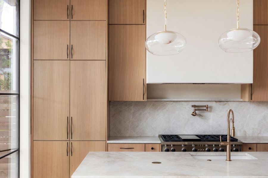Kitchen featuring light stone counters and modern cabinets