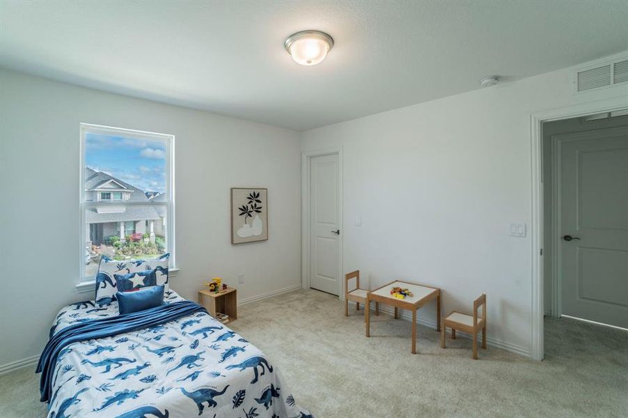 Bedroom with light carpet and baseboards Bedroom with light carpet and baseboards