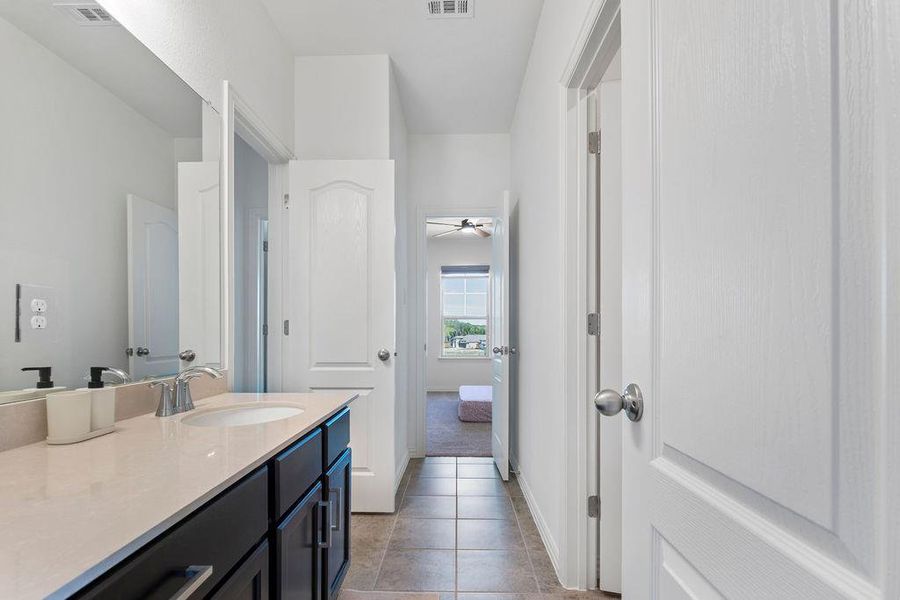 Bathroom featuring vanity and light tile patterned floors Bathroom featuring vanity and light tile patterned floors