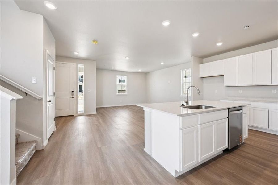 A kitchen with white cabinets.