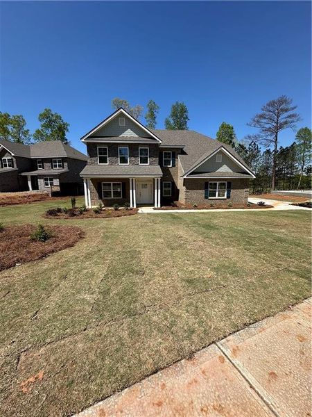 Front exterior of a new home in Mirror Lake at South Harbour, Villa Rica, GA, highlighting curb appeal (Image 20).