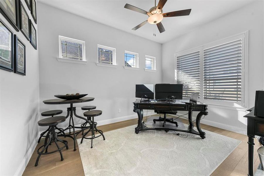 Office with ceiling fan and light hardwood / wood-style flooring