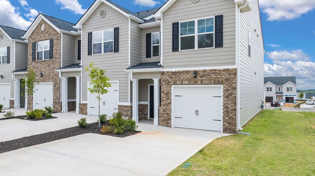 Front exterior of a new home in The Parish at Flat Rock Townhomes, Graniteville, SC, highlighting curb appeal (Image 19). Front exterior of a new home in The Parish at Flat Rock Townhomes, Graniteville, SC, highlighting curb appeal (Image 19).