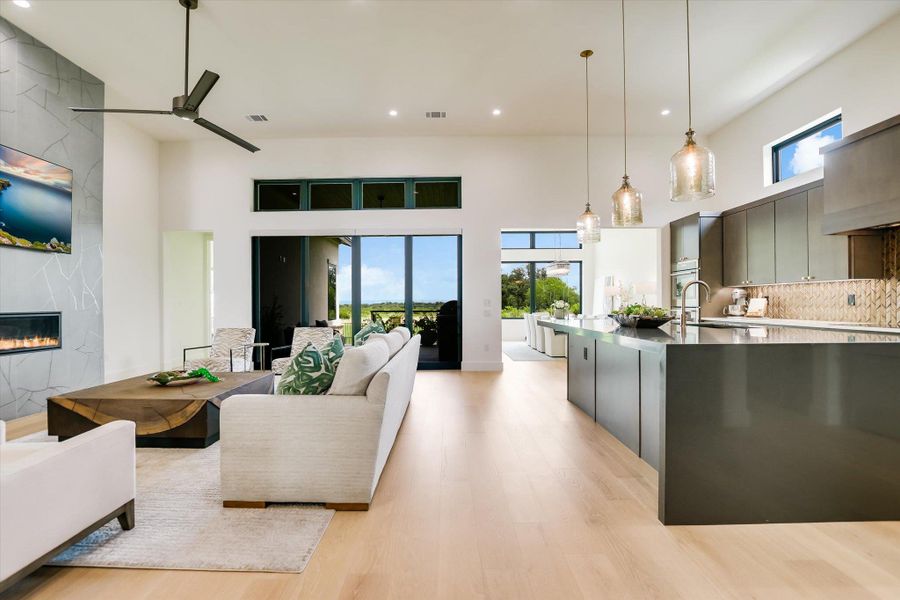 A spacious, airy interior with high ceilings and beautiful views showcases an open-concept design.