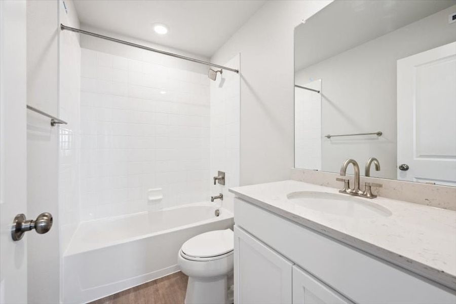 A bathroom with a tub sink and toilet.