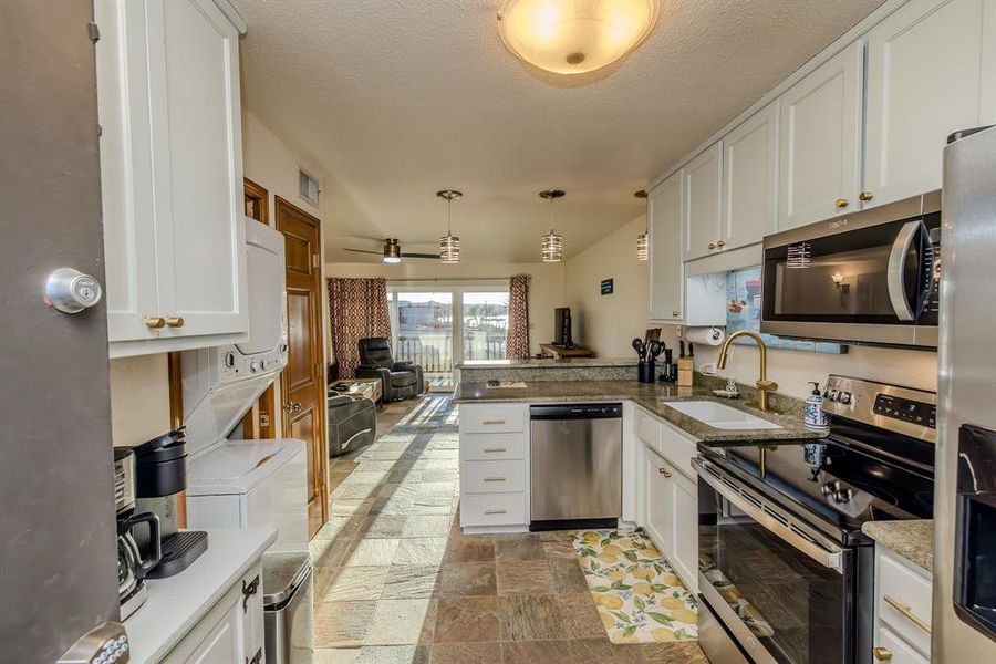 When you arrive at your condo, your entrance is straight into the kitchen, with ample counter and cabinet space to unload any groceries, drinks, snacks, etc.