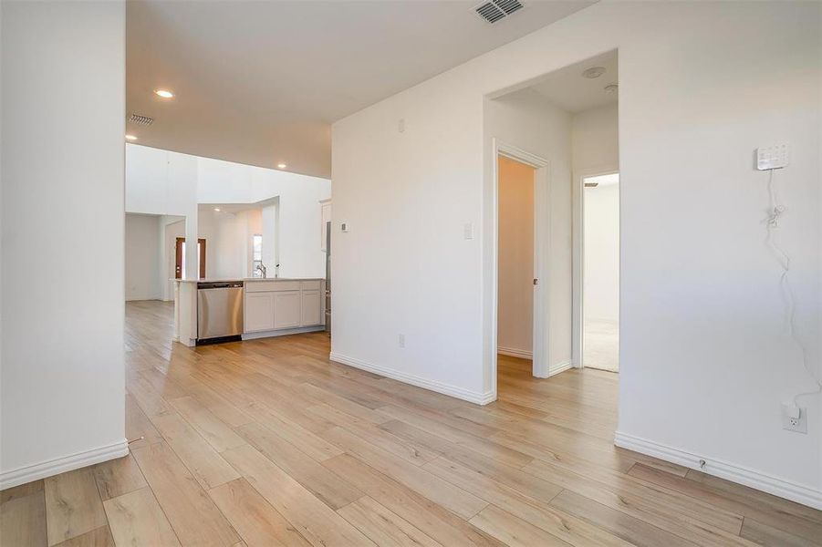 Unfurnished room featuring light hardwood / wood-style flooring and sink