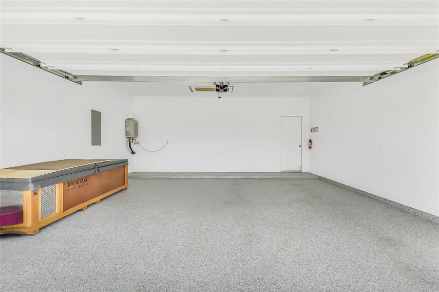 Spacious garage with clean finishes and ample room for vehicles, storage, or workshop use. Bright overhead lighting and organized layout make the space both functional and versatile.