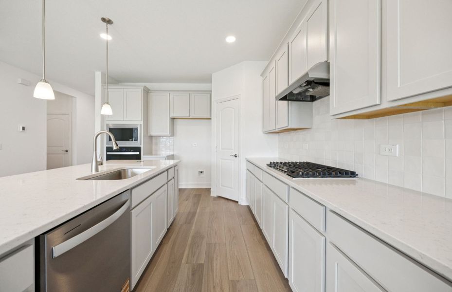 Spacious kitchen with oversized island  *real home pictured