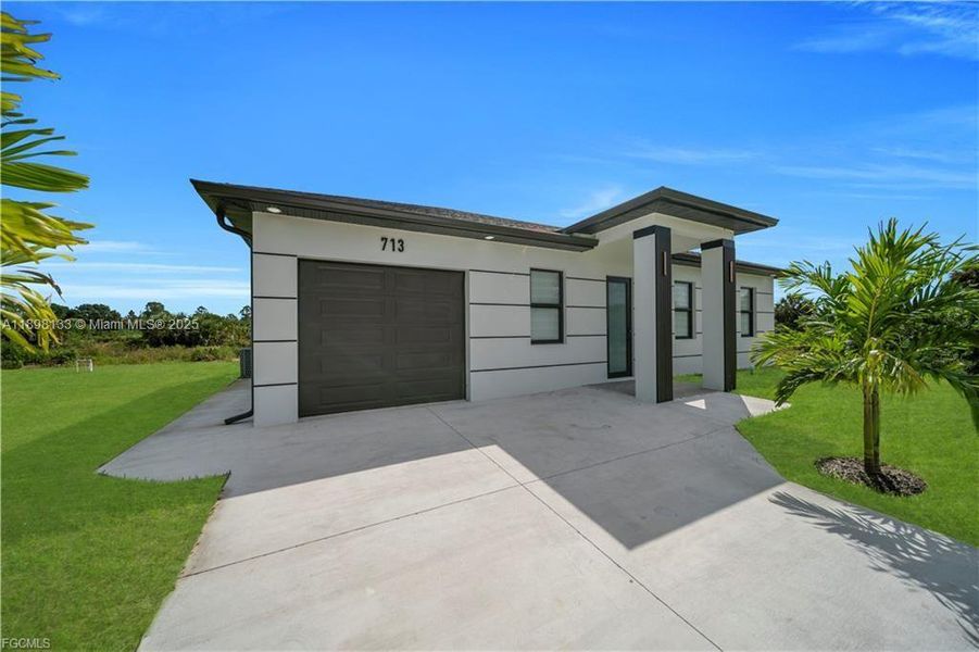 Front exterior of a new home in , Lehigh Acres, FL, highlighting curb appeal (Image 1). Front exterior of a new home in , Lehigh Acres, FL, highlighting curb appeal (Image 1).