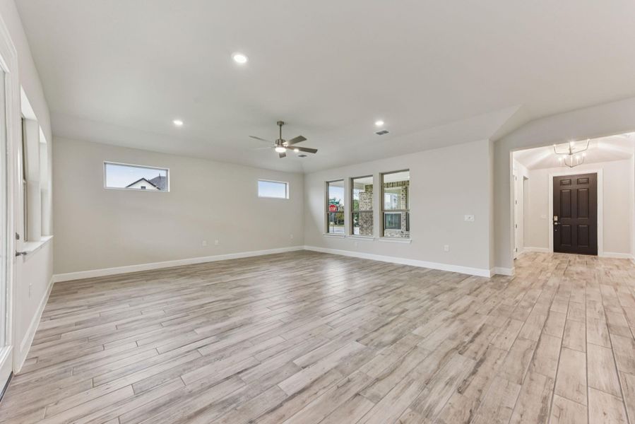 Unfurnished living room featuring light wood finished floors, recessed lighting, and a ceiling fan