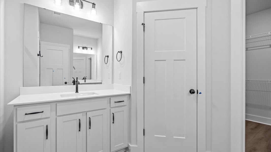 Tasteful primary bath with modern finishes, tiled walk-in shower & double vanity layout at Silo Ridge in Anderson, SC