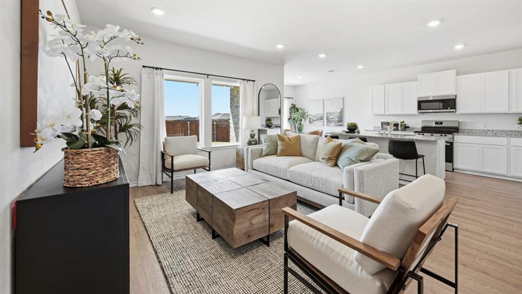 Living area with light wood finished floors and recessed lighting Living area with light wood finished floors and recessed lighting