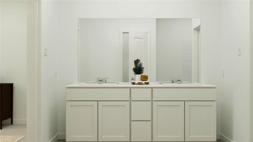 Bathroom featuring double vanity and baseboards