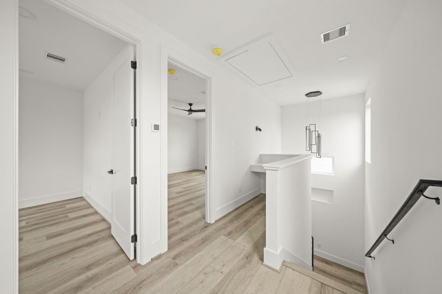 The third level landing area features a dedicated study nook which overlooks the decorative display niche and large windows in the stairwell, as well as a stunning chandelier light fixture. The third level landing area features a dedicated study nook which overlooks the decorative display niche and large windows in the stairwell, as well as a stunning chandelier light fixture.