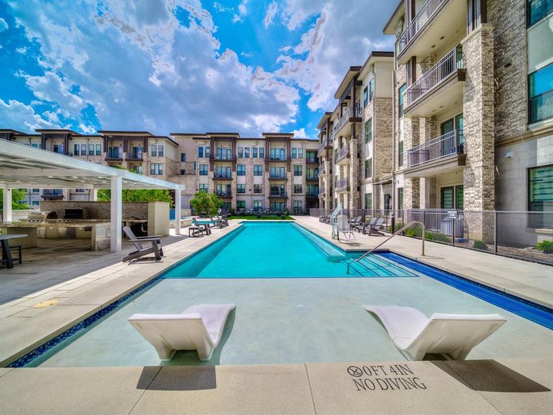 Community pool with a grill and a patio Community pool with a grill and a patio
