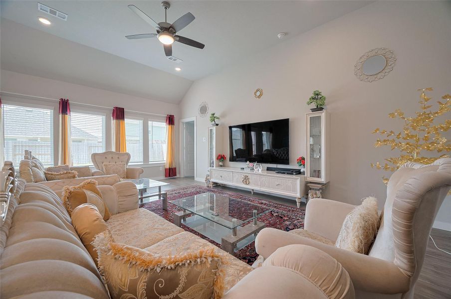 Master bedroom with tray ceiling and ceiling fan.