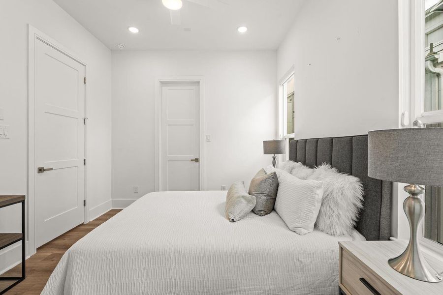 Framed by oversized windows, the room captures natural light from morning through evening, bringing warmth and dimension to the interior. The result is a space that feels connected, comfortable, and effortlessly livable.