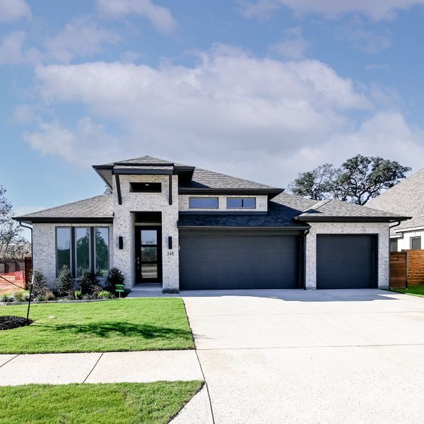 Front exterior of a new home in Juniper Springs, Lockhart, TX, highlighting curb appeal (Image 24).