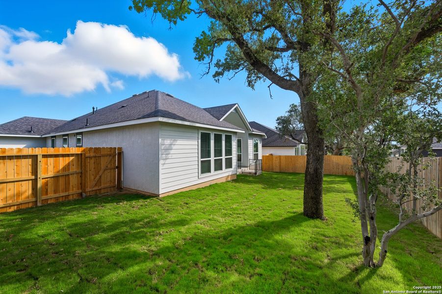 Exterior details and patio area of a home in The Reserve at Potranco Oaks, Castroville (Image 18).