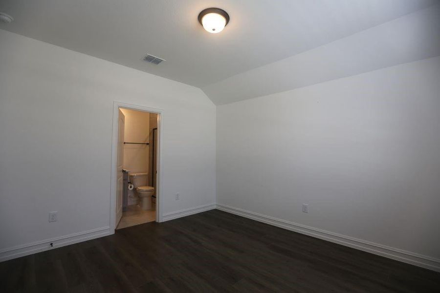 Room featuring wood-finish flooring, white walls, and a semi-flush mount ceiling light