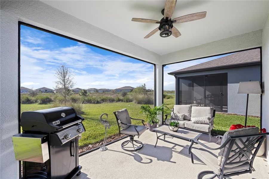 Panoramic screening and a ceiling fan make outdoor living, oh so lovely