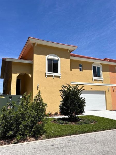 Front elevation showing first level garage and second level living space.