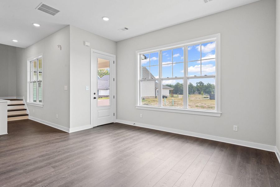 Foyer entrance with dark wood-type flooring, recessed lighting, and stairway Foyer entrance with dark wood-type flooring, recessed lighting, and stairway