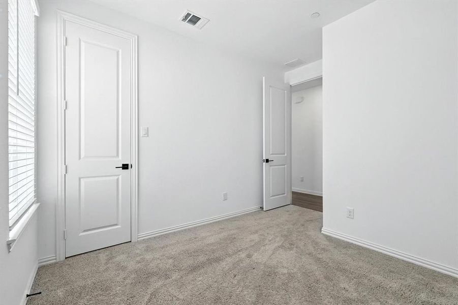 and a view from the bedroom of the hallway that leads to the entry and stairway